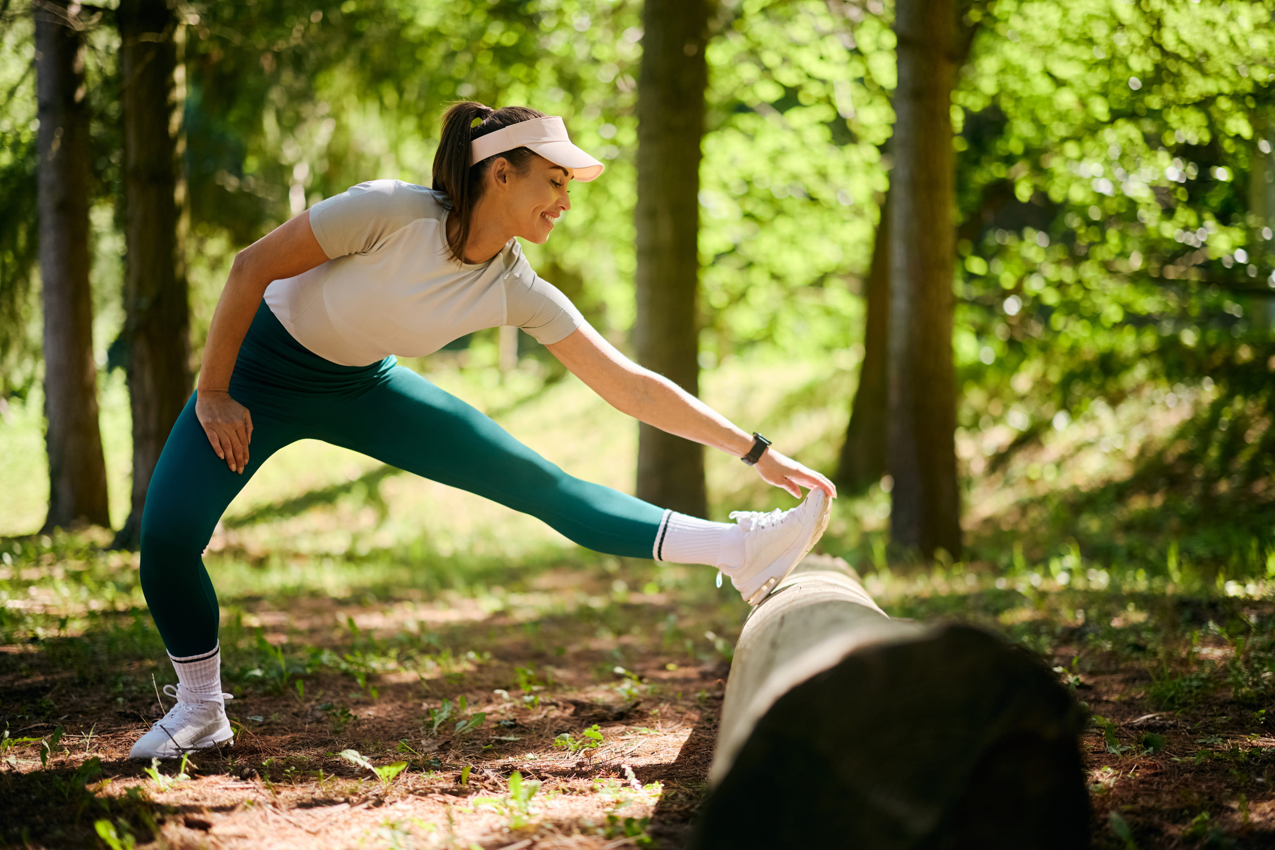 Woman working out by stretching on log